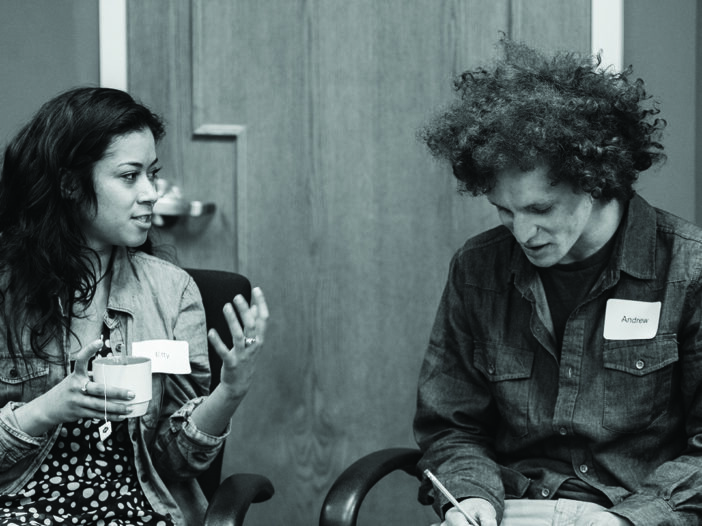 black and white image of two people having a discussion